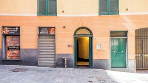 A building with a sign for a wellness center, a service center, and a massage center. - Aquarium 5'| 1BR | A/C| By Tilo (Genoa)