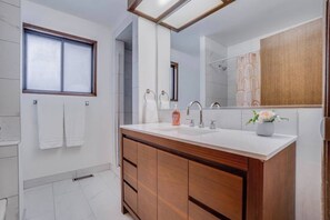 A modern bathroom with a large mirror, wooden vanity, and a window. - Dolly - Large Home, Fast Wi-Fi, BBQ & Dbl Garage (Edmonton)
