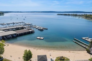 A marina with boats, a pier, and a beach area. - Harbor Cottage: 4  BR, 3.5  BA Cottage in Harbor Springs , Sleeps 12 (Harbor Springs)