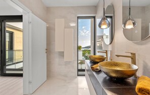A modern bathroom with a large mirror, two pendant lights, and a large bowl sink. - Stunning home in Tribunj (Tribunj)