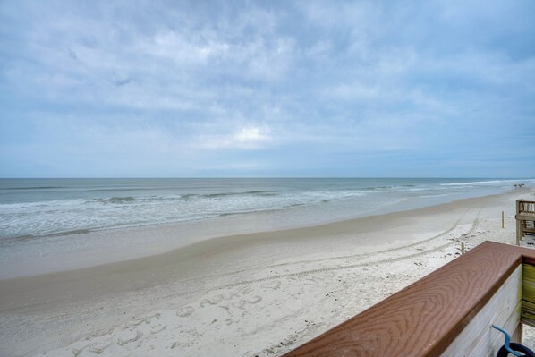 A beach view with a wooden railing, sandy beach, and ocean. - Sun, Sand, Poolside Vibes! Daytona Shores Retreat (Daytona Beach Shores)