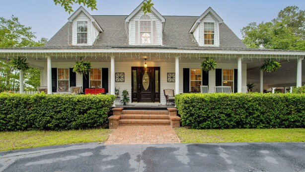 A two-story house with a porch, a front door, and a brick pathway leading to the entrance. - On Horse Farm! Home w/ Gazebo in Aiken (Aiken)