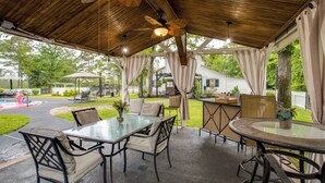 An outdoor patio with tables and chairs, a ceiling fan, and a view of a house. - On Horse Farm! Home w/ Gazebo in Aiken (Aiken)