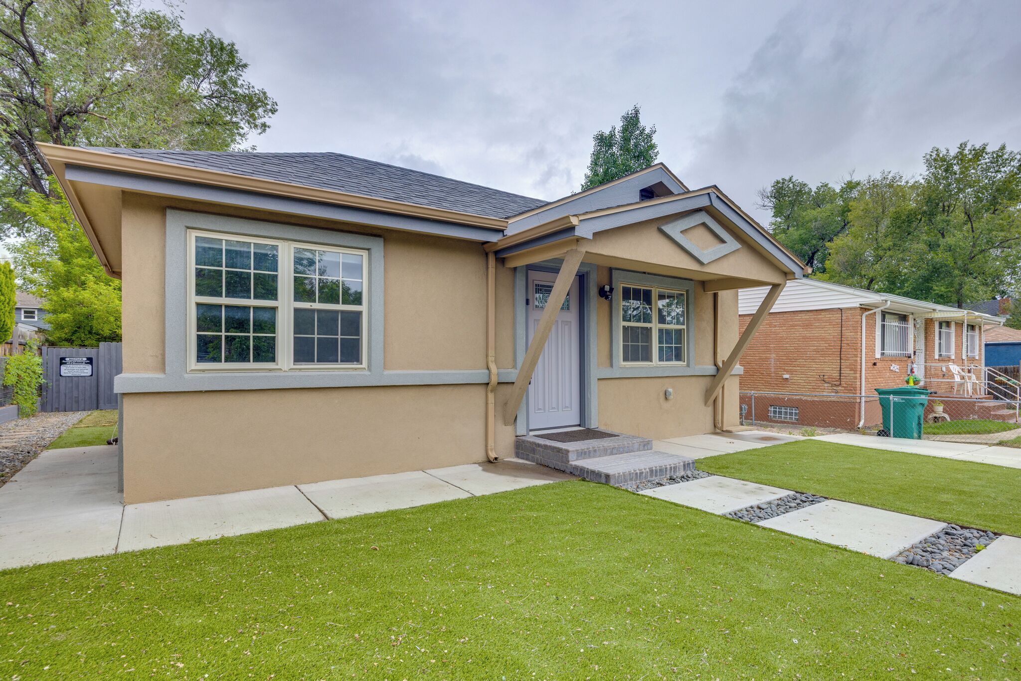 A single-story house with a front porch, a garage, and a well-maintained lawn.