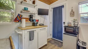 A compact kitchen with a microwave, coffee maker, and a small refrigerator. - Tiny House Experience in Las Vegas w/ Free Parking (Las Vegas)
