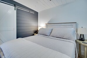 A bedroom with a bed, a nightstand with a lamp, and a wardrobe with a sliding door. - < 1 Mi to Bull Shoals Lake! Family-friendly Escape (Lakeview)