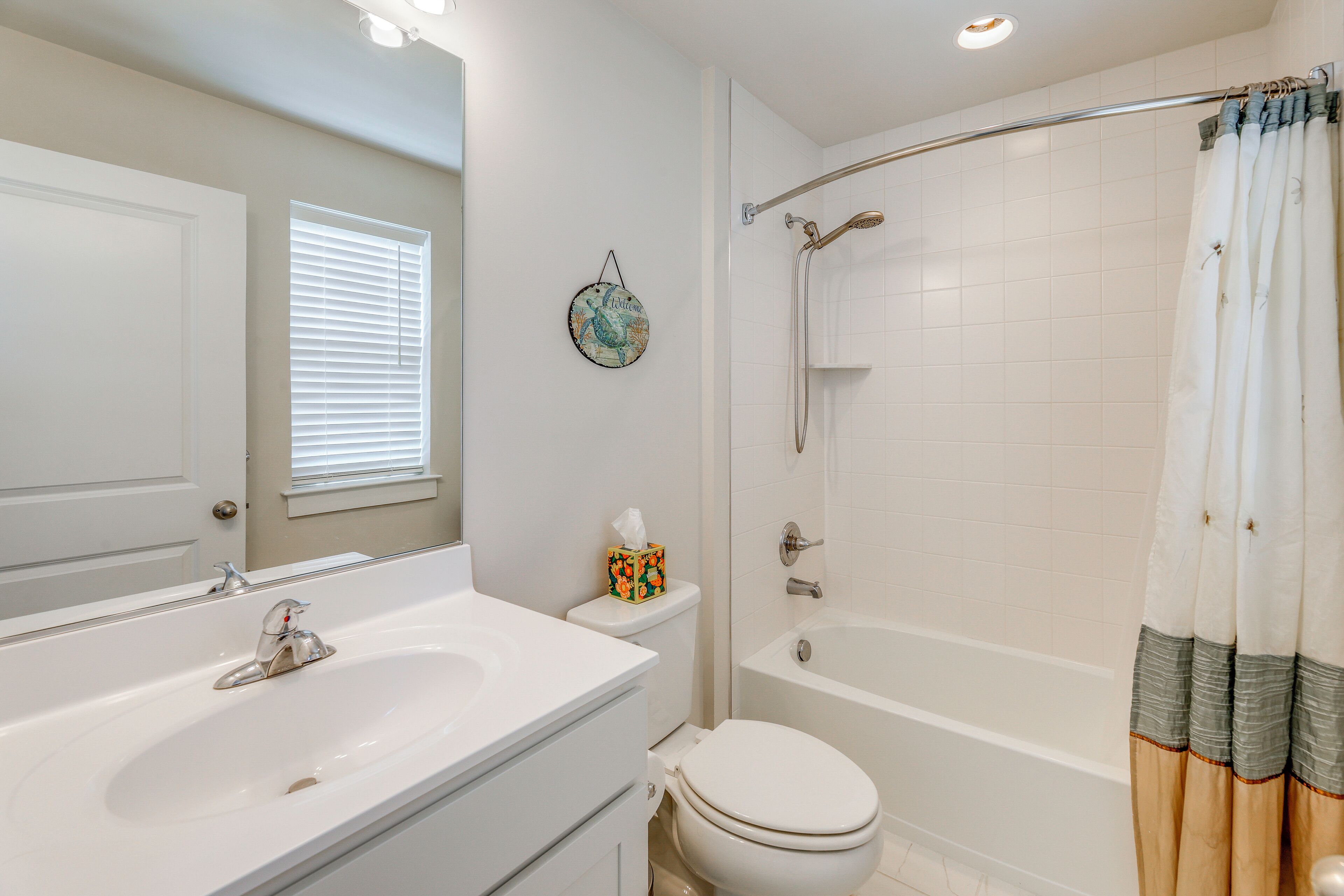 A bathroom with a sink, toilet, and bathtub.