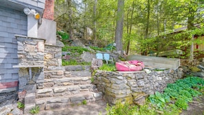 A stone staircase leading to a house with a boat on the roof. - Lakeside Berkshires Cabin w/ Private Dock & Views (Lee)