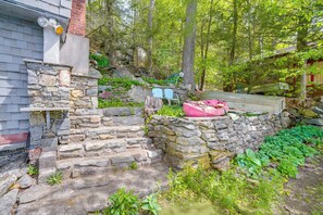 A stone staircase leading to a house with a boat on the roof.
