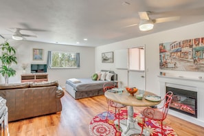 A modern living room with a sofa, dining table, chairs, a fireplace, and artwork on the walls. - Beach, Hot Tub & Mtn Views! Dolores Couple's Gem (Cortez)