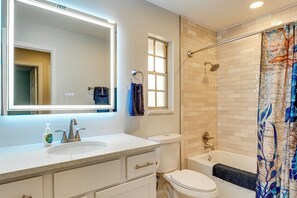 A bathroom with a white sink, mirror, toilet, and bathtub. - Patio w/ Views! Pet-friendly Keystone Heights Home (Keystone Heights)