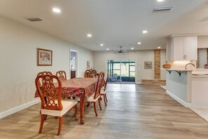 A dining area with a table set for six, wooden chairs, a ceiling fan, recessed lighting, and a view to the outside. - Patio w/ Views! Pet-friendly Keystone Heights Home (Keystone Heights)