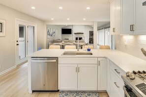 A modern kitchen with white cabinetry, a dishwasher, and a built-in oven. - Game Room! Upscale Family Retreat in Murfreesboro (Murfreesboro)