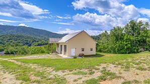 A single-story building with a gabled roof, a front door, and a small porch area. - Pet-friendly Home w/ Stunning Views in Sparta! (Sparta)