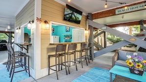 A beach house with a bar area, outdoor seating, and a staircase. - Shared Pool & Hot Tub! Seaside Murrells Inlet Home (Murrells Inlet)