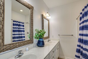 A bathroom with two sinks, a large mirror, and a shower curtain. - Walk to Beach! Murrells Inlet Oasis w/ Shared Pool (Murrells Inlet)