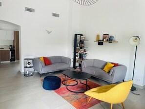 A modern living room with two grey sofas, a blue bean bag, a yellow chair, a black coffee table, and a bookshelf. - Large Provencal house (Pujaut)