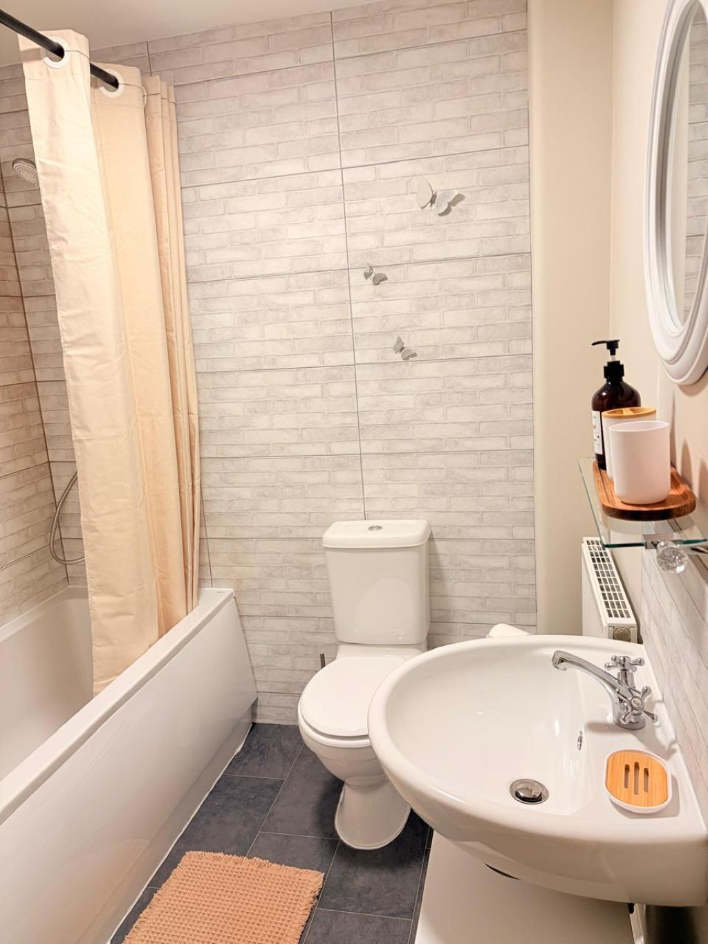 A bathroom with a bathtub, toilet, and sink.