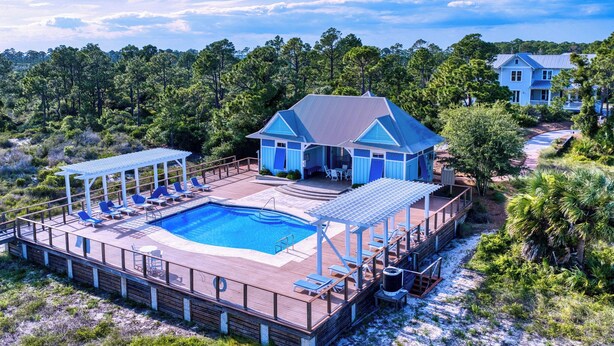 A large house with a swimming pool, a covered deck, and a view of the surrounding forest. - Gulf View Pool | Deeded Beach Access | Jubilation | Sleeps 11, Boat Parking (Pot St Joe)