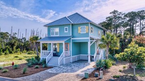 A two-story house with a porch, a staircase, and a well-maintained garden. - Gulf View Pool | Deeded Beach Access | Jubilation | Sleeps 11, Boat Parking (Pot St Joe)