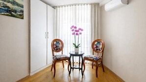 A room with two chairs, a small table, a potted plant, and a painting on the wall. - My Way Teras Hotel (Adalar)