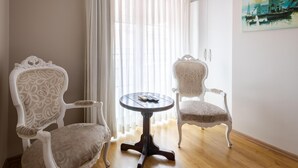 A room with two ornate chairs, a small round table, and a window with sheer curtains. - My Way Teras Hotel (Adalar)