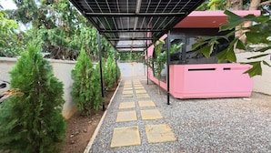 A pathway with stepping stones leading to a covered area with solar panels.