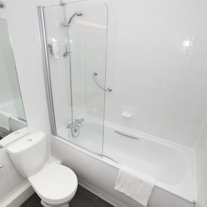 A modern bathroom with a glass-enclosed shower, a toilet, and a bathtub.