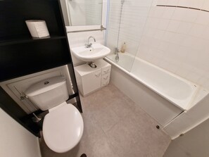 Ein Badezimmer mit Toilette, Waschbecken und Badewanne.