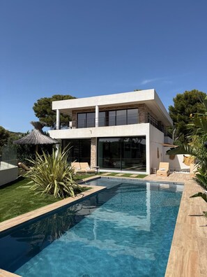 A modern two-story house with a swimming pool, outdoor seating, and a thatched umbrella. - Villa d'Exception sur la Presqu'île de Cassis - Heated pool & calanques view (Cassis)