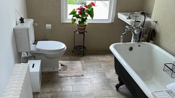 Combined shower/bathtub, deep-soaking bathtub, towels