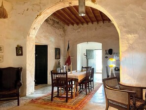 An interior with a dining area, a sofa, and a lamp. - Cortijo with eclectic décor near Almería (Albaricoques)