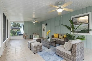 A covered patio area with wicker furniture, a ceiling fan, and a view of the outdoors. - Horsey Heartland oasis 7 Mi WEC Close to all Fun (Ocala)