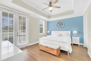 A bedroom with a bed, bedside tables, a ceiling fan, and a window with blinds. - Reunion Resort 3 Bed, 2 Bath with Pool Views & Golf Course (Kissimmee)