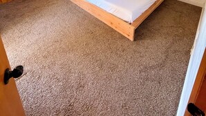 A bedroom with a single bed, a ceiling fan, a window with curtains, and wooden wardrobes. - 3-bedroom house in peaceful Sierras on 4.5 acres along road to Bass Lake (Wishon)