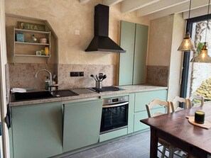 A kitchen with a sink, stove, and cabinets. - The Palm Trees of Regnèville (Regnéville-sur-Mer)