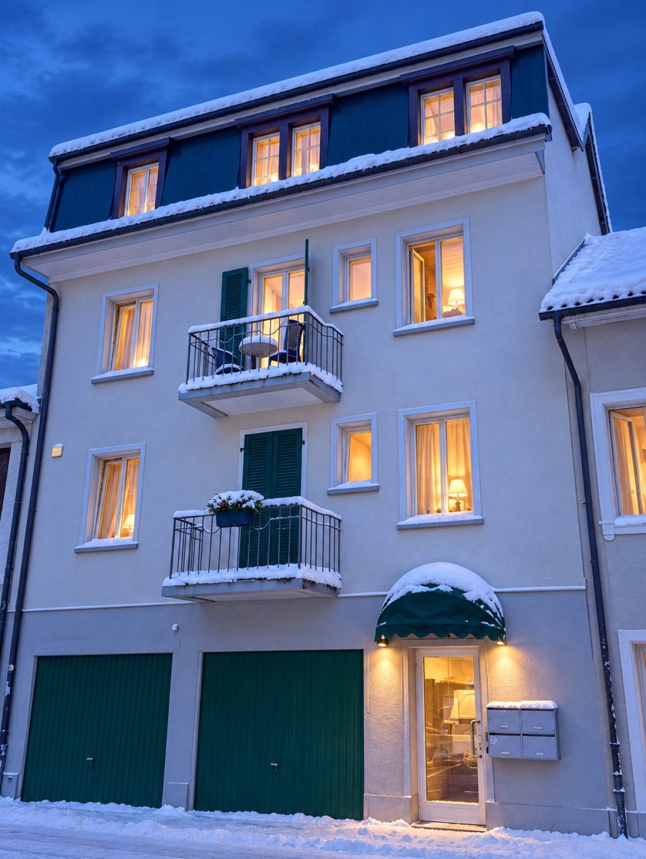 A multi-story building with a balcony, windows, and a door.