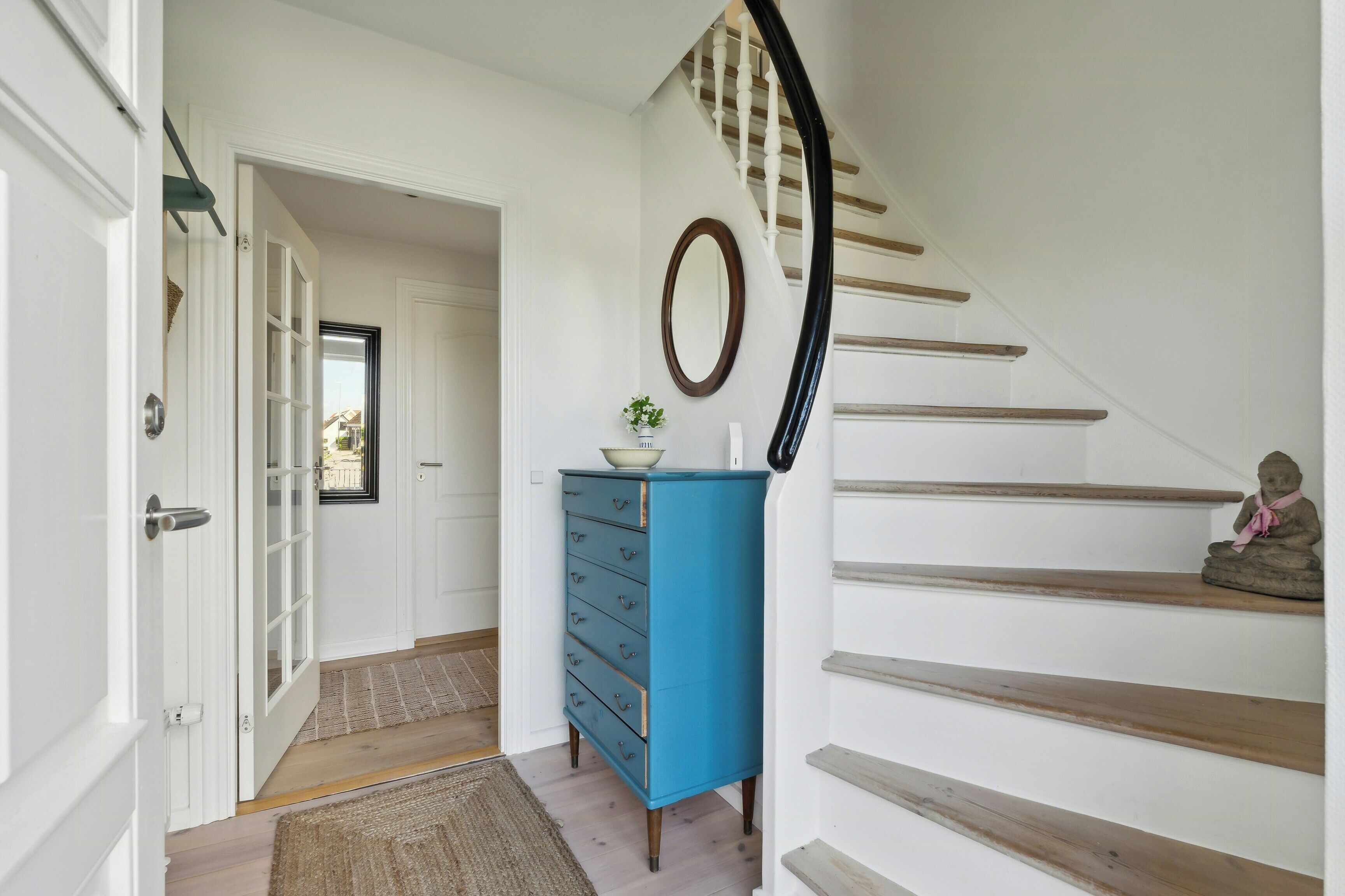 A staircase with wooden steps and a white wall.