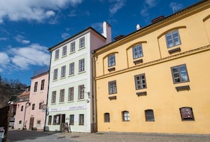A row of colorful buildings with a sign for 'Donna' and 'AIMUNTE RAJNA 63' visible.