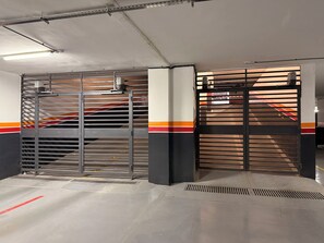 A parking garage with metal gates, concrete floors, and ventilation grates. - Cosy apartment in the center of Marrakech (Marrakech)