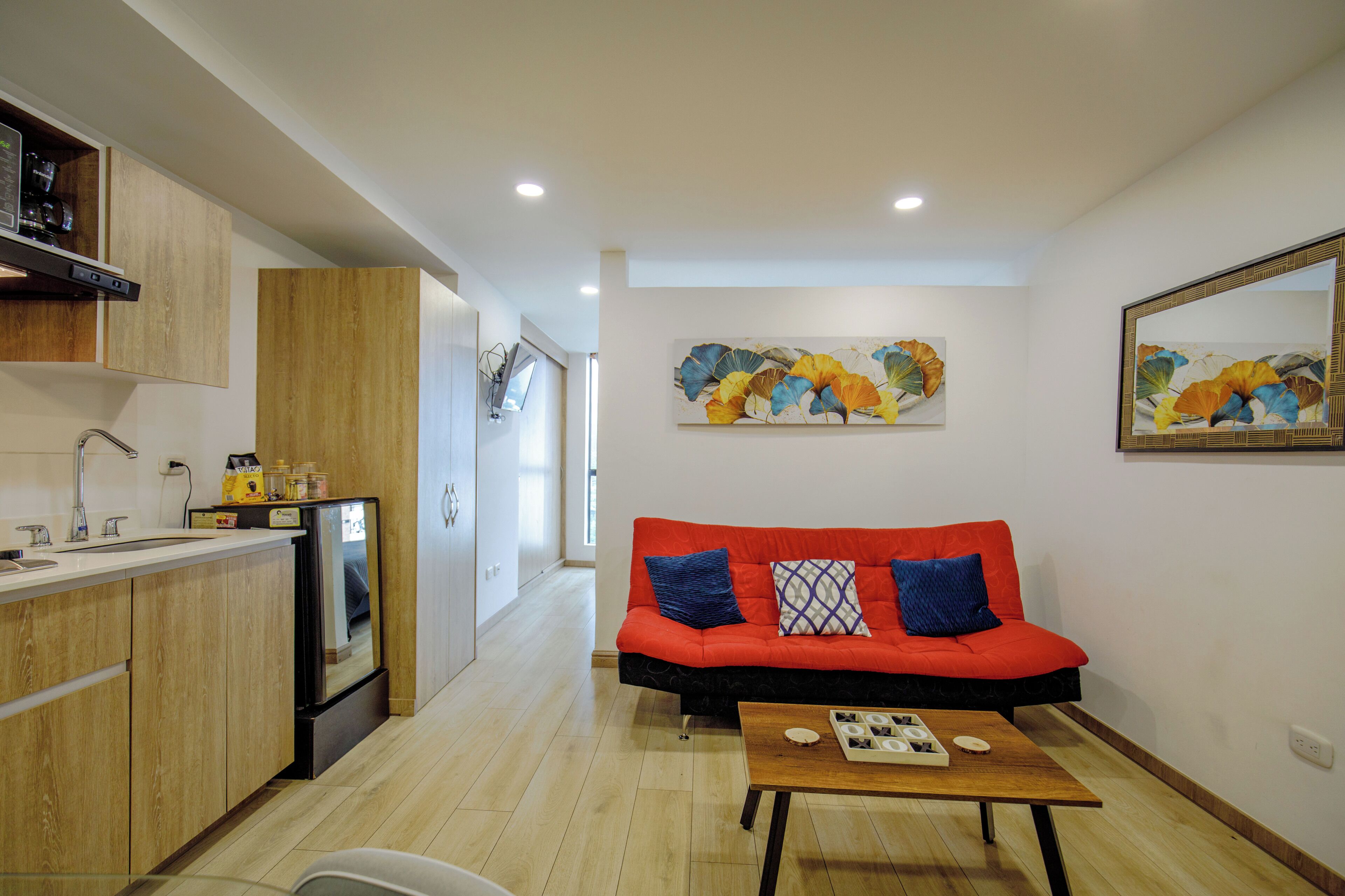 A modern kitchen with wooden cabinets, a built-in oven, and a countertop.
