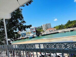 A marina with boats, a hotel, and a waterfront promenade.