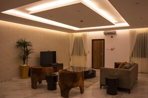 A modern living room with a flat-screen TV, a glass coffee table, and a sofa. - Sun Heaven Residence Lekki (Lekki)