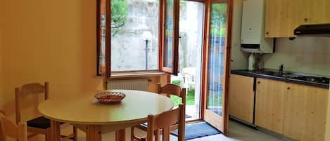 Fridge, stovetop, cookware/dishes/utensils, dining tables