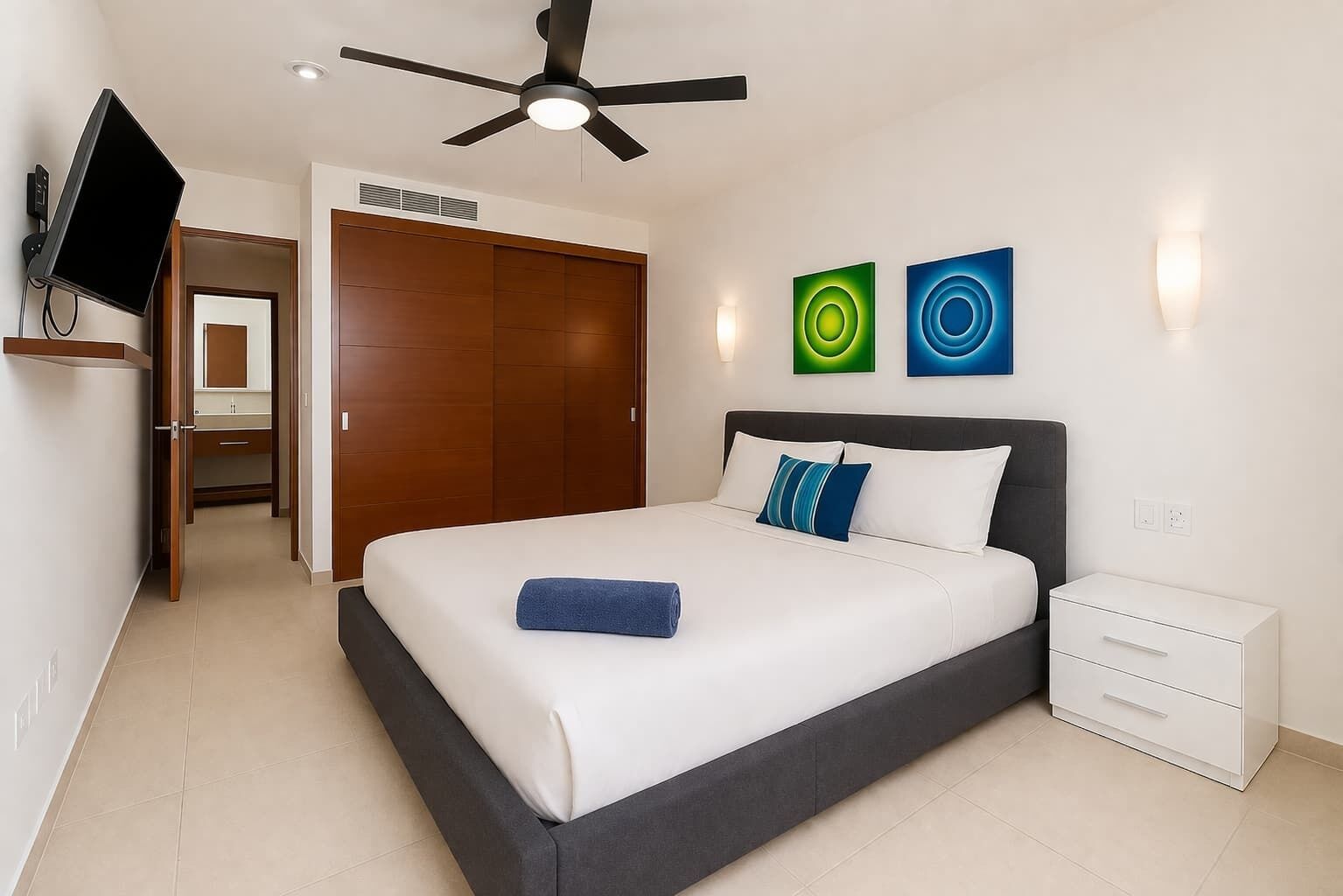 Bedroom with queen bed, smart TV and ceiling fan