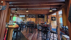 A restaurant with a wooden interior, tables and chairs, and a sign reading 'Mountain View Lounge'. - Charming family-friendly 3-bedroom mountain condo with AC in scenic Campton (Campton)