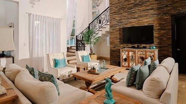 A living room with a sofa, armchairs, a coffee table, a TV, and a staircase. - Lifestyle Holidays Vacation Club (Puerto Plata)