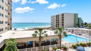 A hotel with a pool, beach view, and multiple floors. - Beachfront PCB 2BR Condo w Pools, Tennis & Gulf Views + Free Attraction Tix! (Panama City Beach)