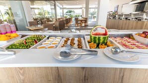 A buffet with various food items and utensils. - Pefkos Breeze Family Resort & Spa (Rhodes)