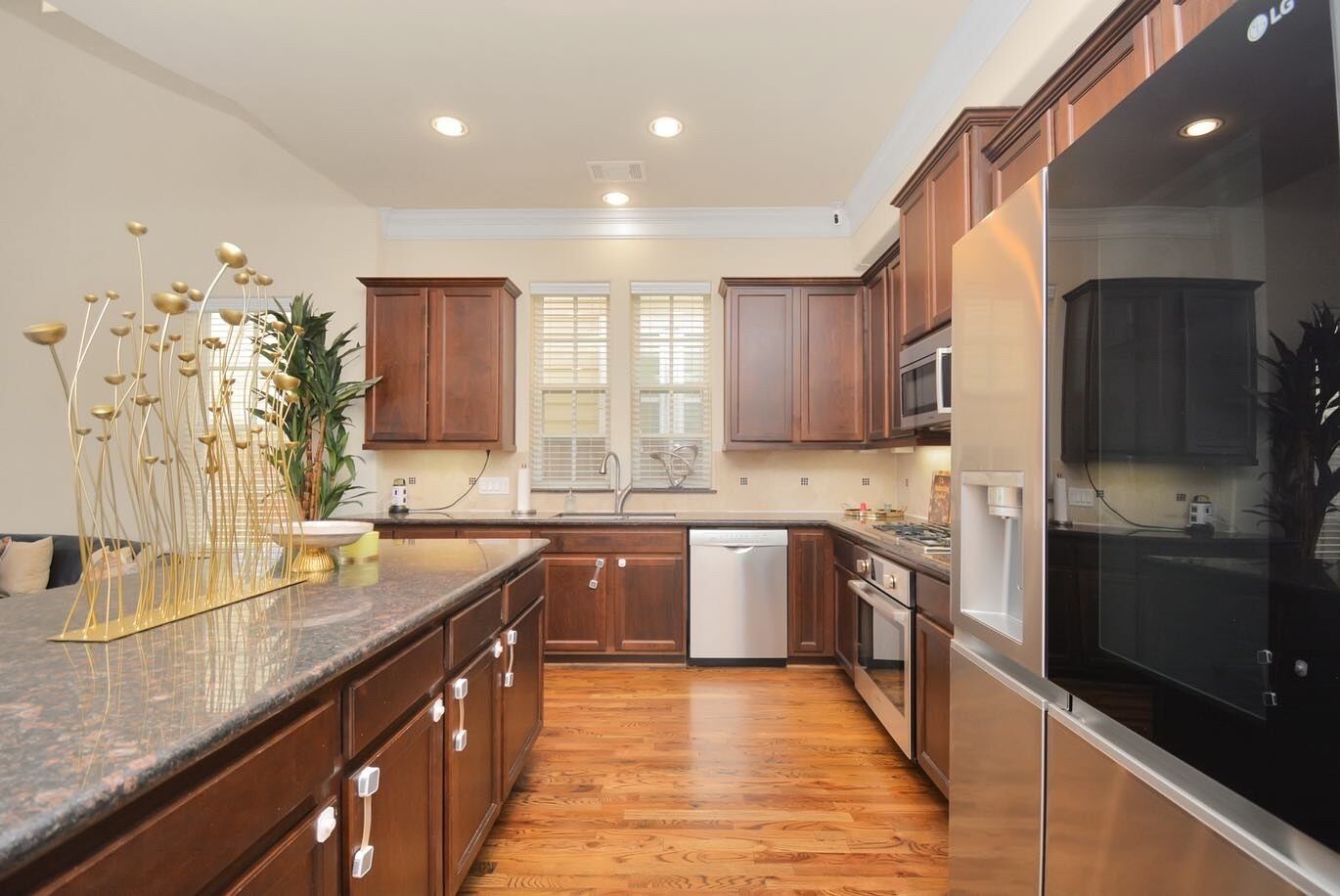 A modern kitchen with wooden cabinets, a dishwasher, and a refrigerator.